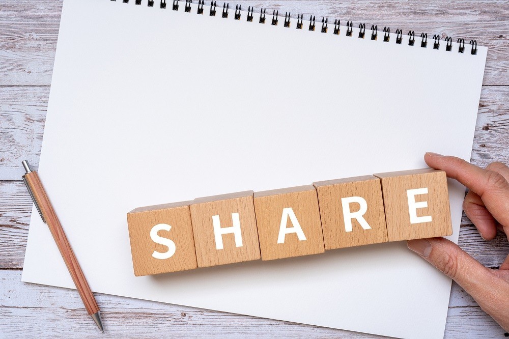 「SHARE」と書かれた積み木とスケッチブック