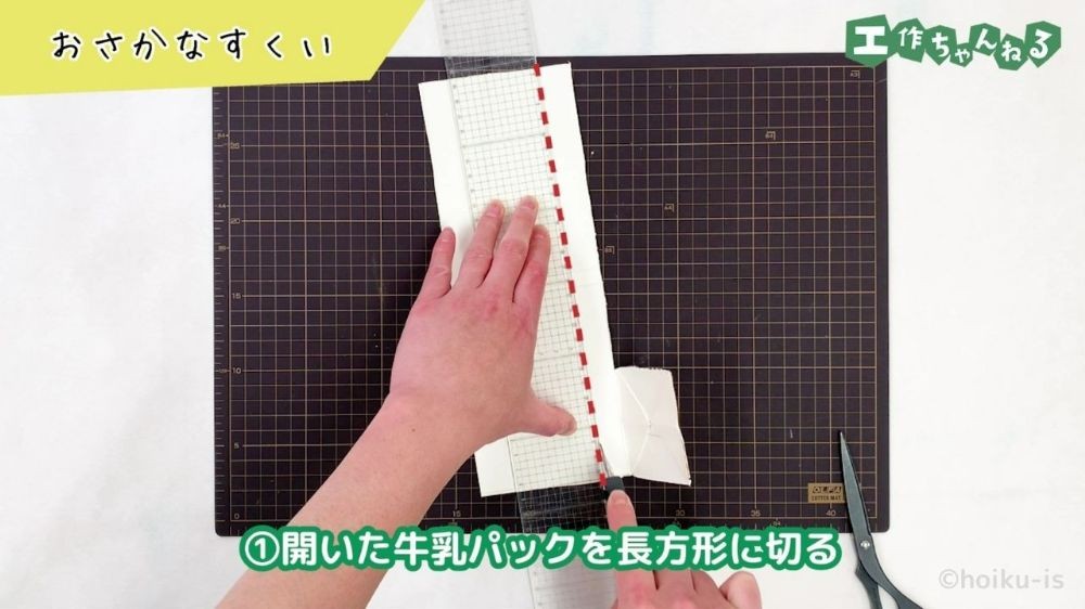 カッターで牛乳パックを切っている手元