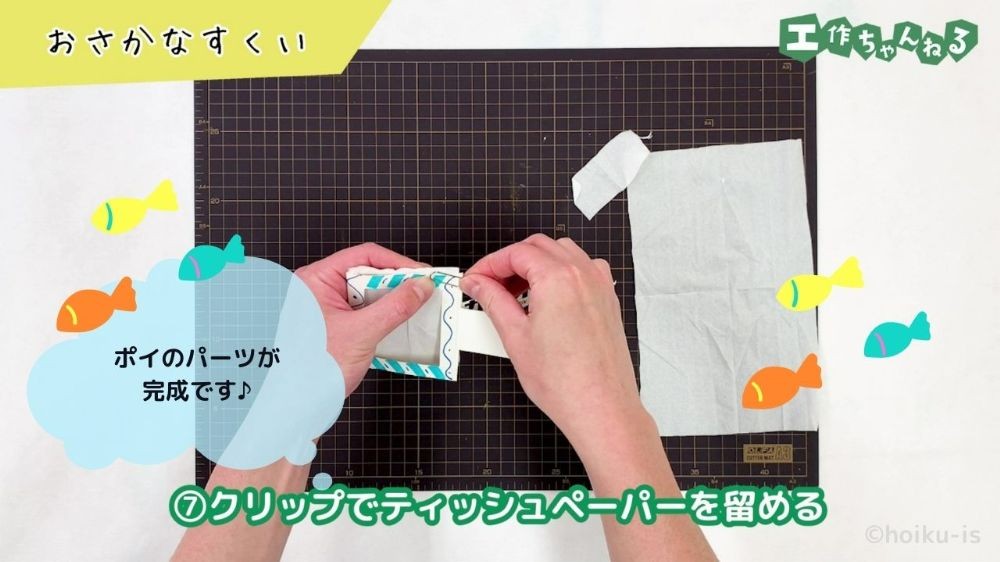 クリップでティッシュペーパーを挟んでいる手元