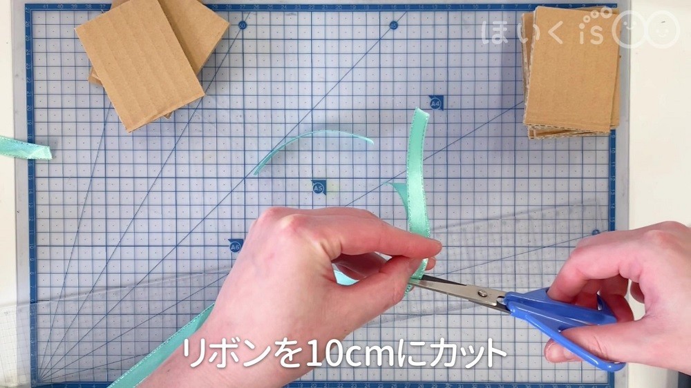 リボンを10㎝にカットしている場面