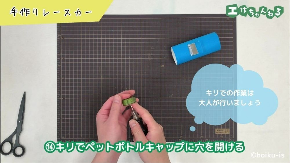 キリでペットボトルキャップに穴を開けている手元