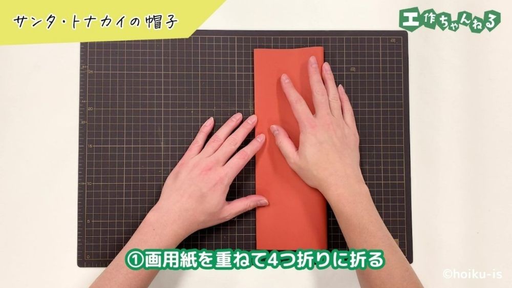 画用紙を4つ折りにしている手元