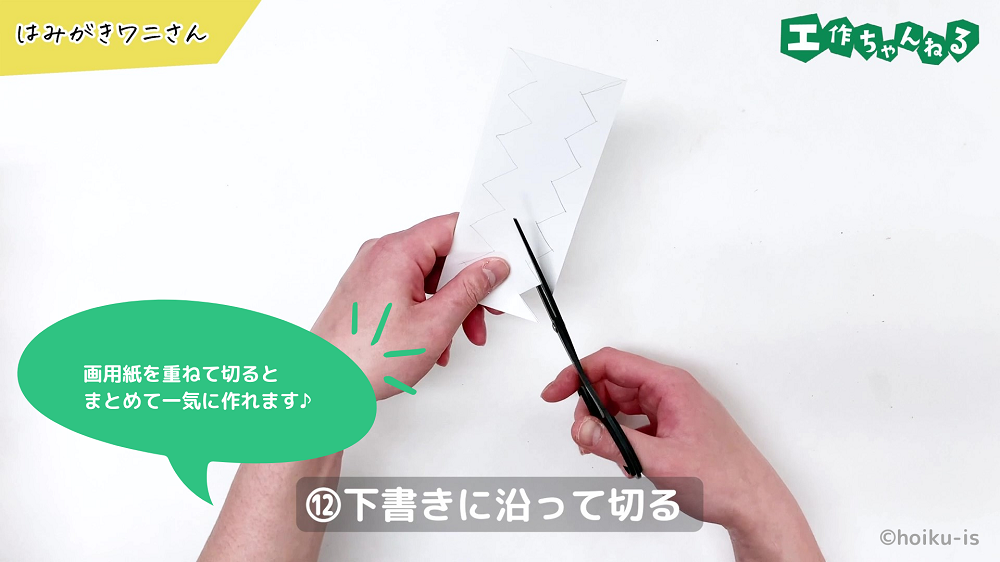 白い画用紙をギザギザに切っている手元