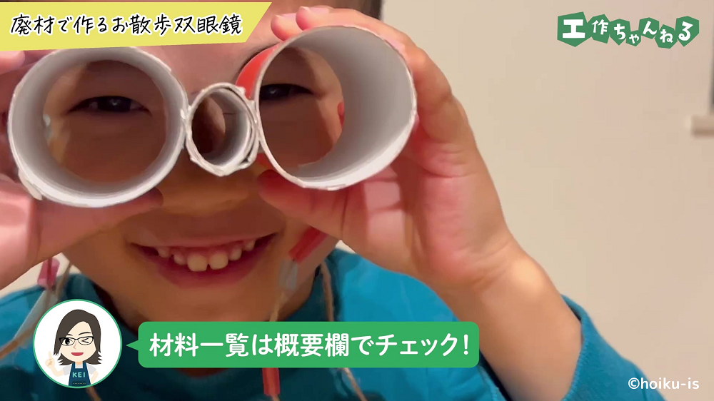 おもちゃの双眼鏡から覗いている子ども
