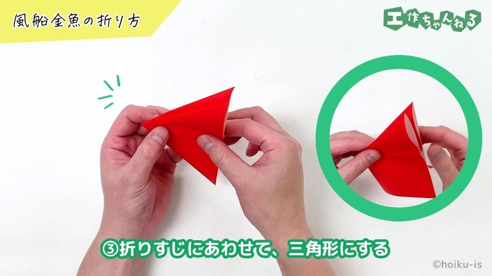 折り紙を折り曲げている手元