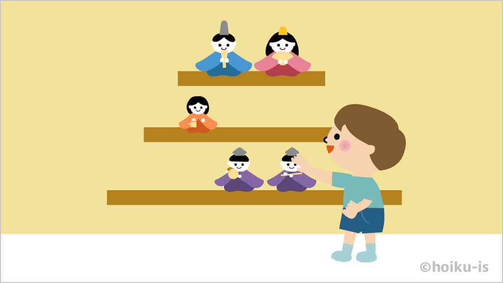 ひな壇を飾り付ける男の子