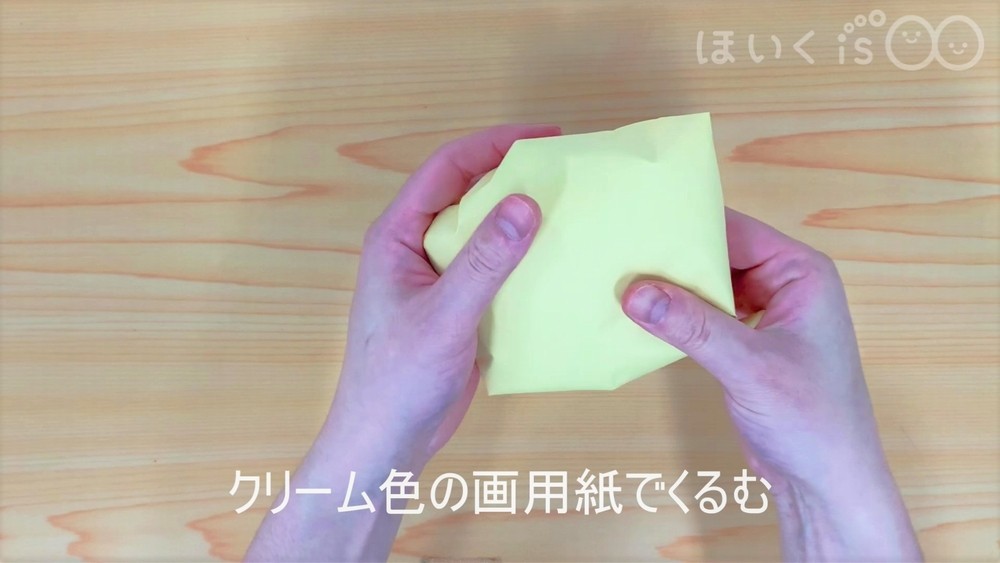 クリーム色の画用紙でくるむ