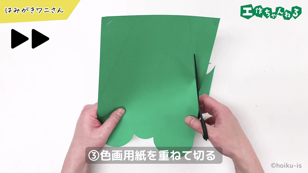 ハサミで色画用紙を切っている手元