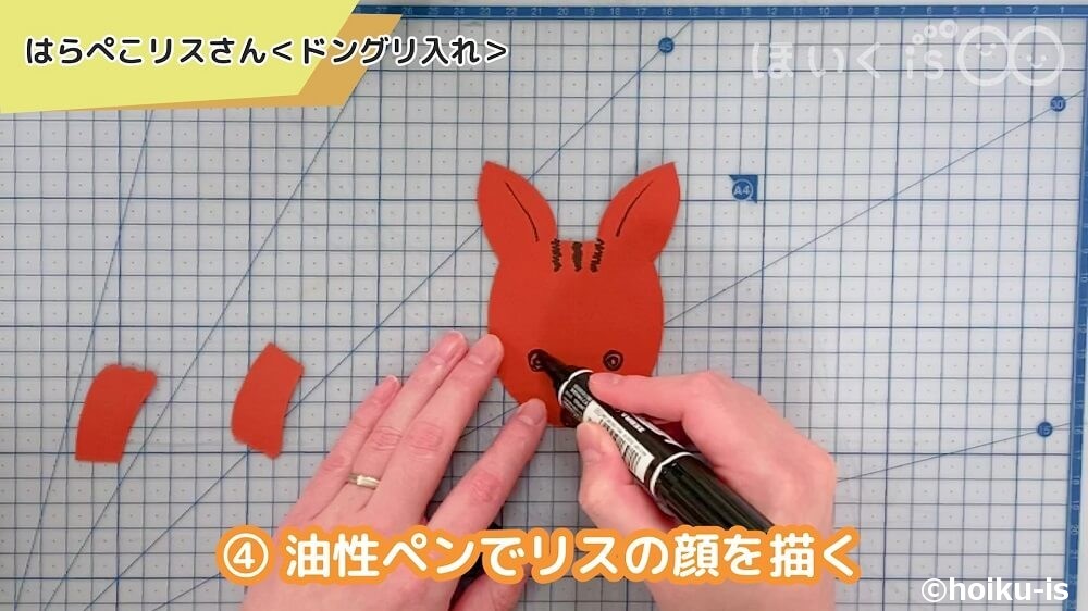 油性ペンでリスの顔を描く