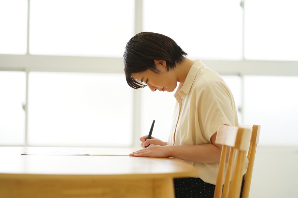 お礼状を書く女性