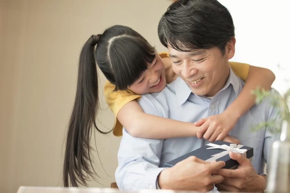 お父さんにプレゼントを渡す女の子