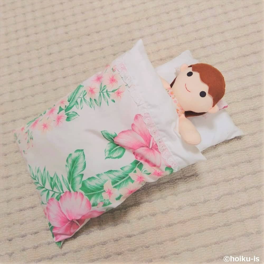 布団と女の子の布おもちゃ